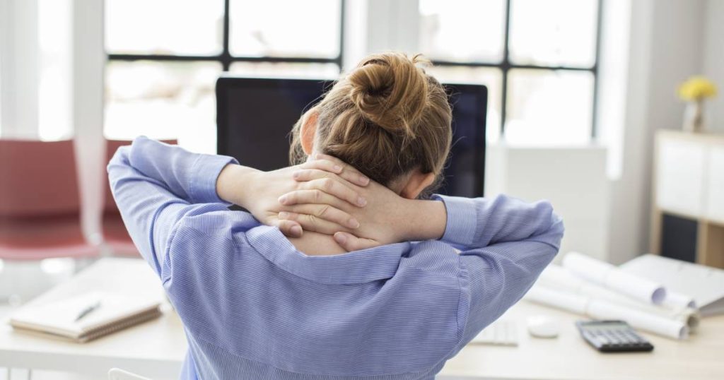 Femme employé en train de détendre sa nuque avec un exercice.